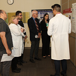 A General Surgery Resident Presenting His Research A General Surgery Resident Presenting His Research