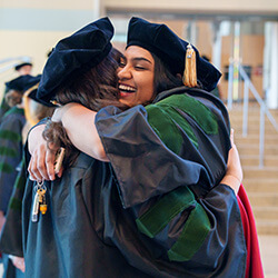 Dr. Rakkar hugs a classmate prior to the Class of 2024 Commencement Dr. Rakkar hugs a classmate prior to the Class of 2024 Commencement